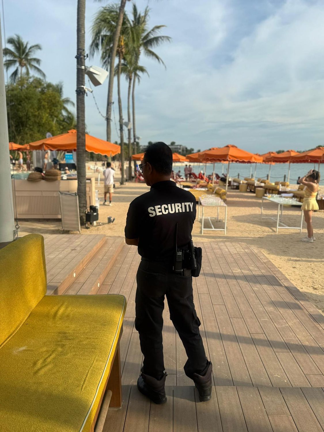 A Hawkeye officer standing watch at a Singapore beach club