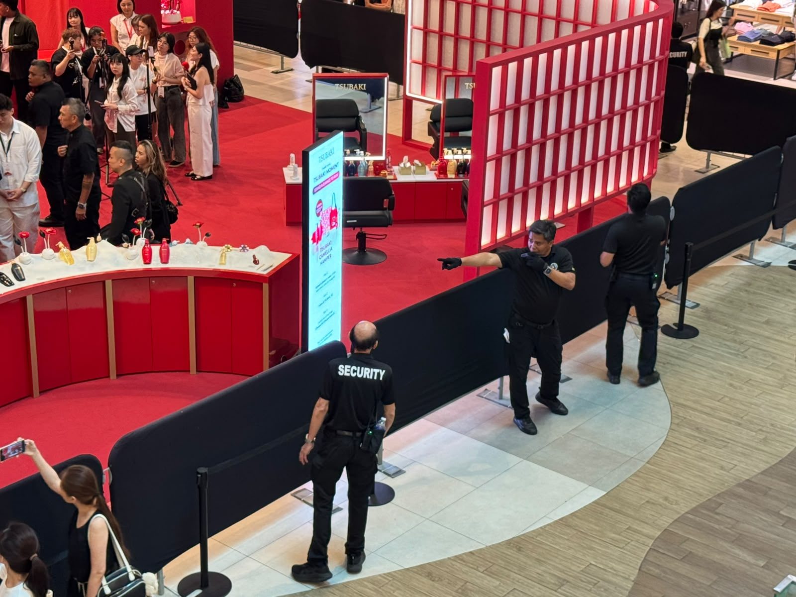Hawkeye officers managing a cordoned crowd at a retail brand launch in a Singapore shopping mall