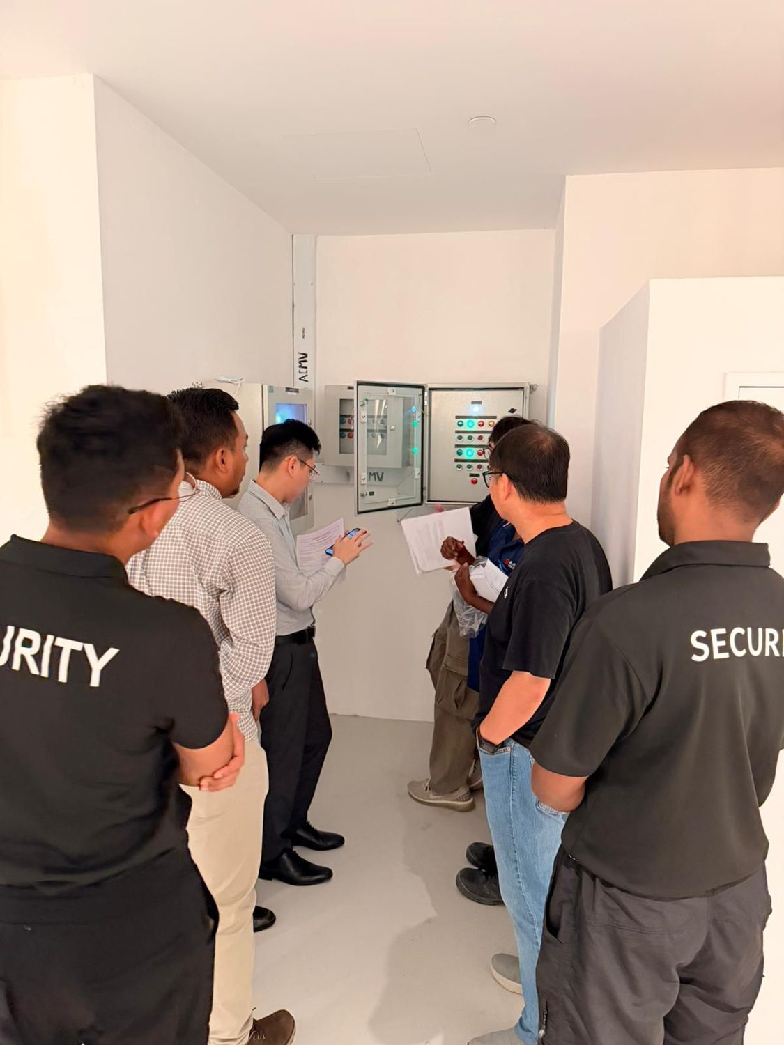 Hawkeye officers at a systems handover with building engineers in Singapore
