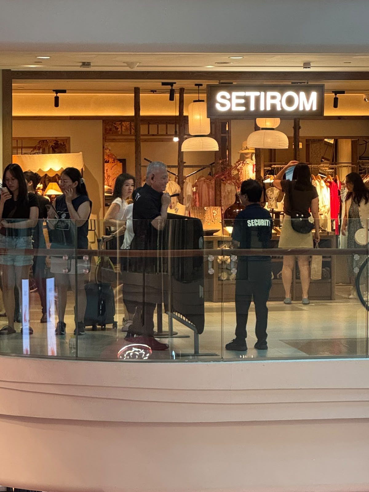 A Hawkeye security officer keeping watch at a shopfront inside a Singapore mall