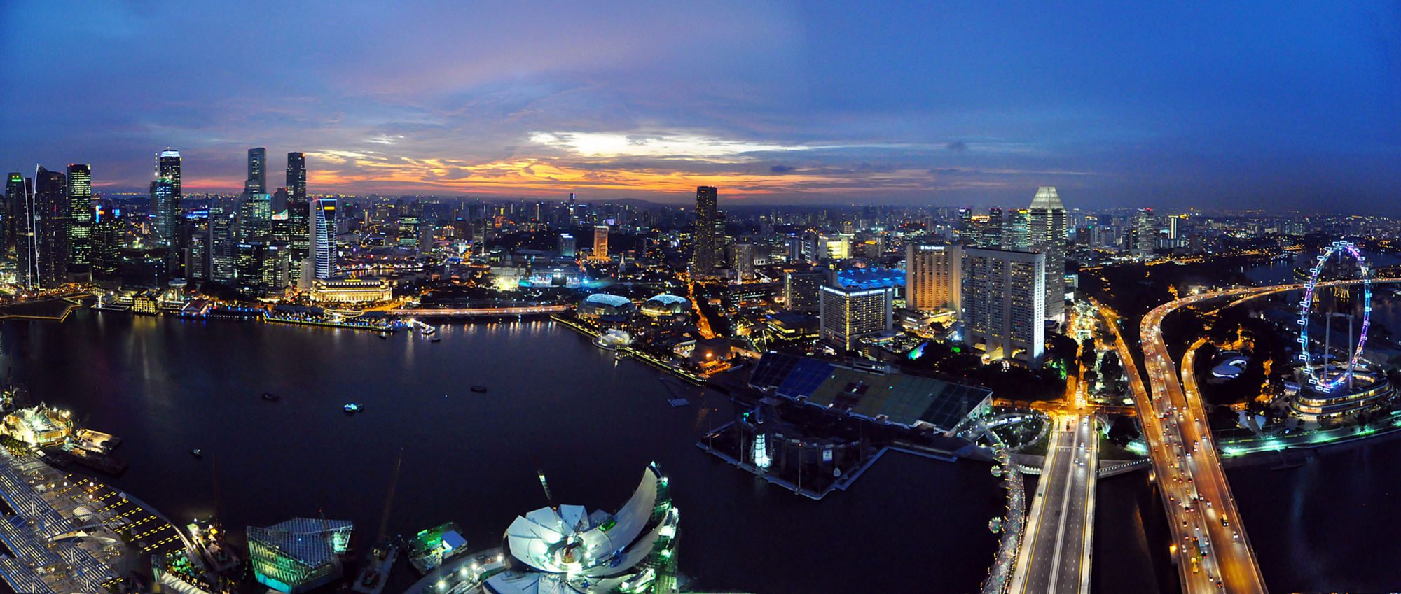 The Singapore skyline at dusk across Marina Bay
